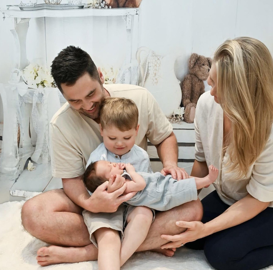 Happy family with sleeping baby